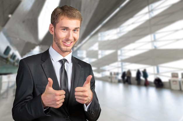 Young Businessman smiling and giving ok