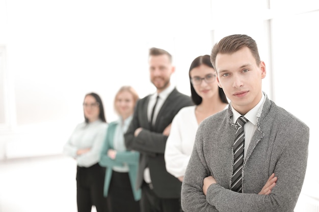 Young businessman standing in front of his business team