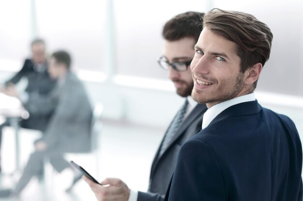 Young businessman standing in a modern office