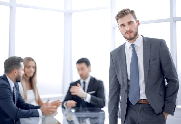 Young businessman standing near the office Desk