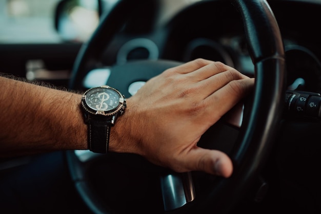 A young businessman in a suit goes to work with car