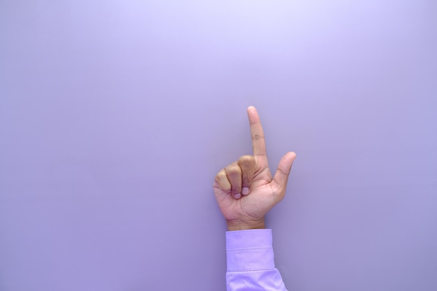 Young businessman in suit point finger top view