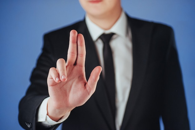 Young businessman in a suit shows his hand