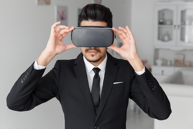 Young businessman in suit and virtual glasses