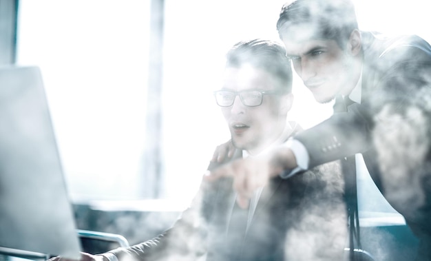 Young businessman at the table smoke in the room