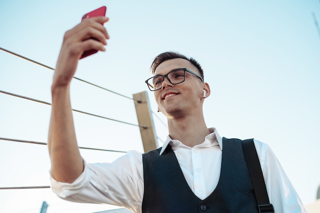 Young businessman taking a selfie on the terrace of a business c