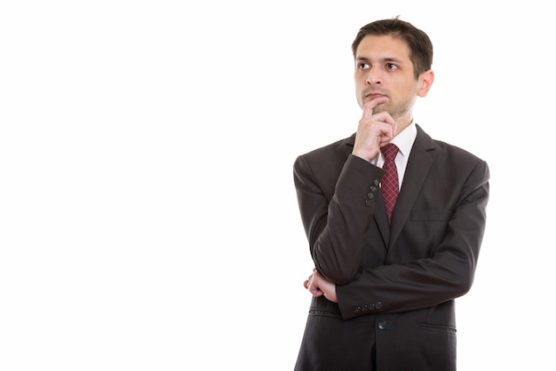 Photo young businessman thinking while looking at distance