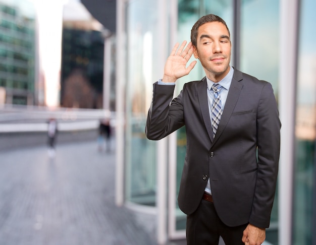 Young businessman trying to listen