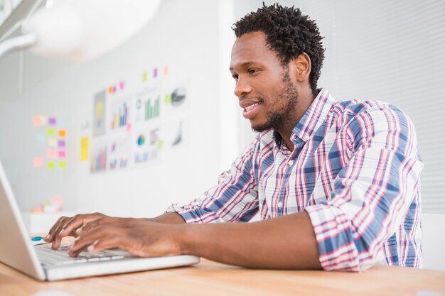 Young businessman types on the laptop