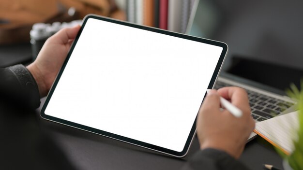 young businessman using blank screen digital tablet in modern office