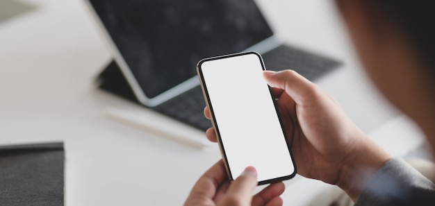 young businessman using blank screen smartphone