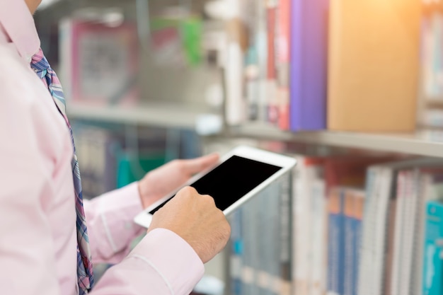 Young businessman using computer tablet in hand