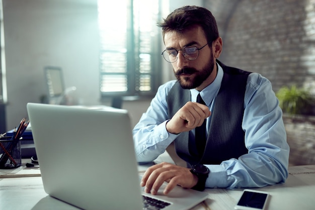 Young businessman using computer while working in the office