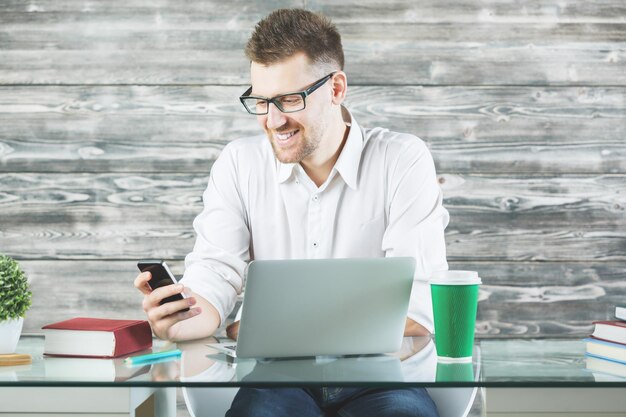 Young businessman using device at workplace