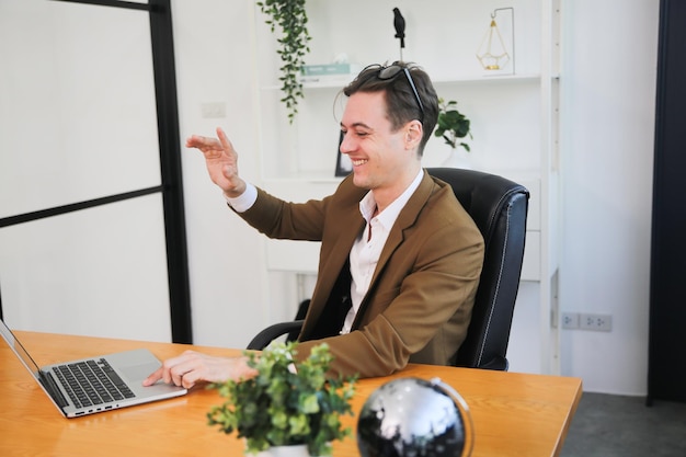 Young businessman using laptop in office