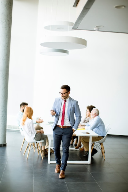 Young businessman using mobile phone in the office