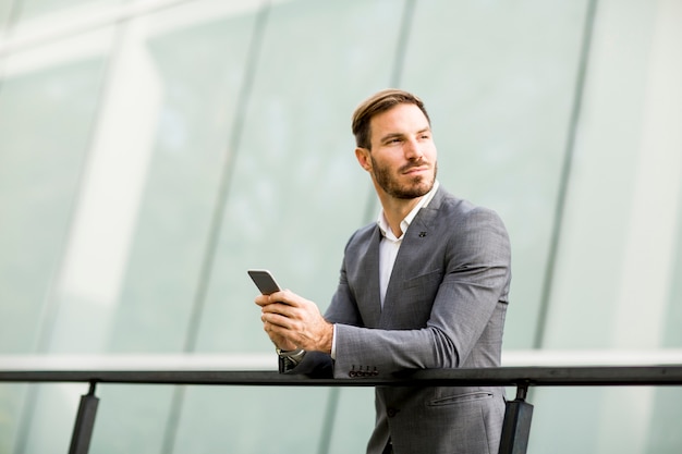 Young businessman using mobile phone at outdoor
