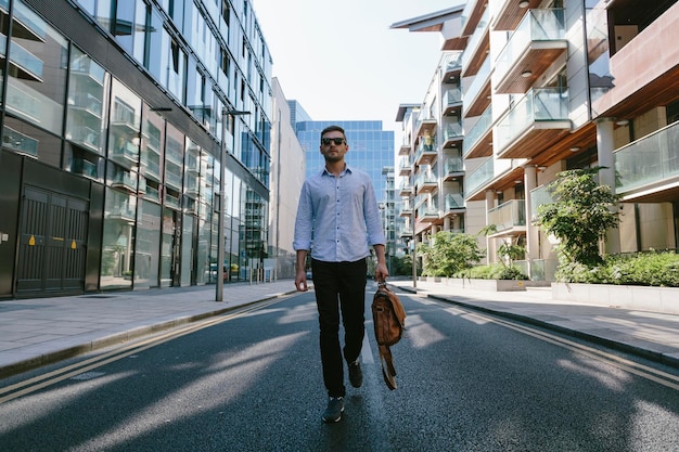 Young businessman walking on street