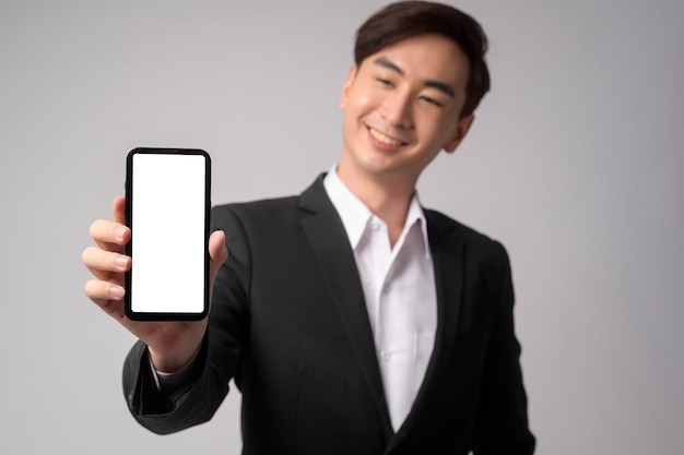 Young businessman wearing suit over white background studio