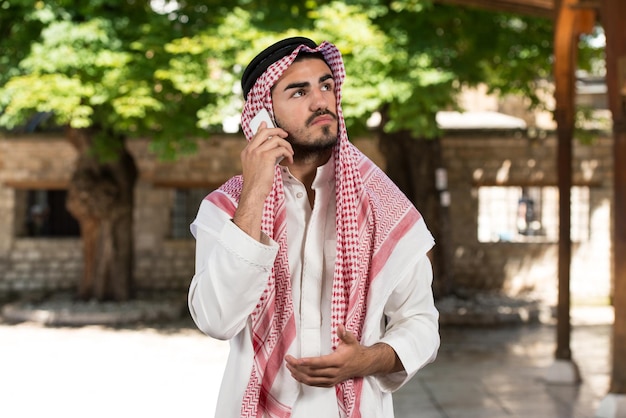 Young Businessman Wearing A Traditional Cap Dishdasha