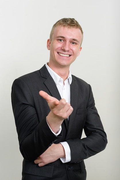 young businessman with blond hair wearing suit on white