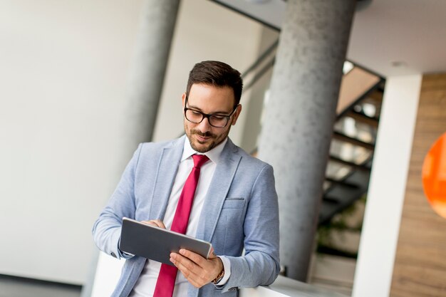 Young businessman with digital tablet in office