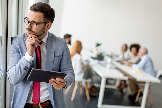 Young businessman with digital tablet in office