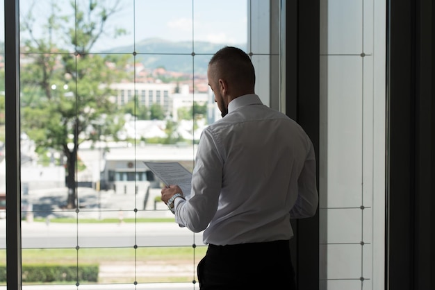 Young Businessman With Document At Office