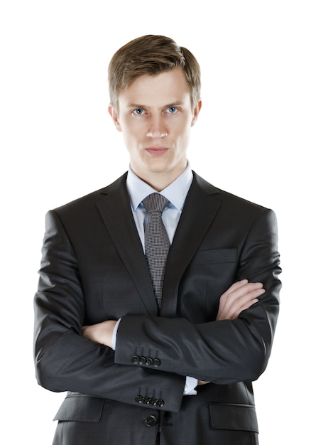 A young businessman with his arms crossed  a stern look. isolated