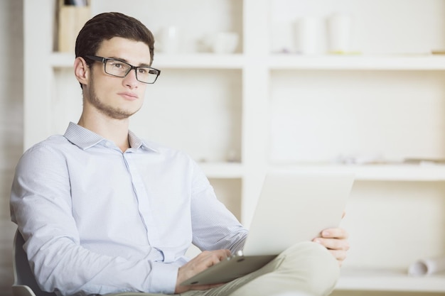 Young businessman with laptop