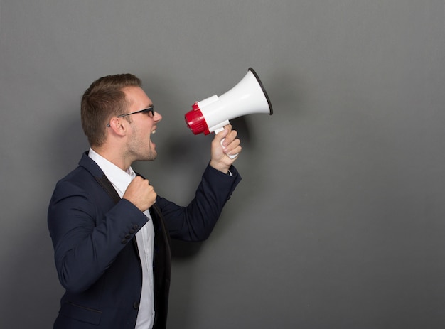 Young businessman with a megaphone