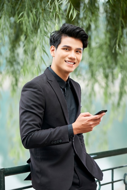 Young businessman with smartphone