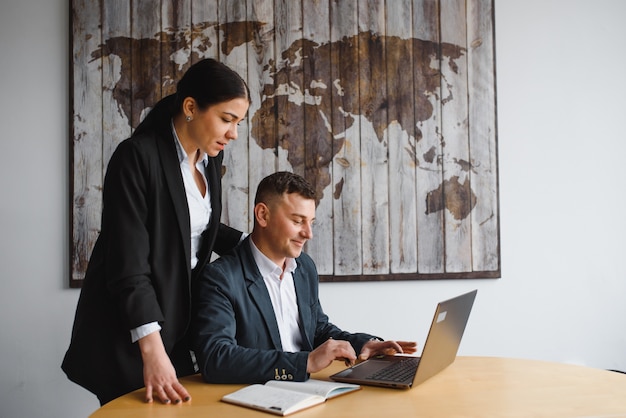 Young businessman and woman working on a laptop