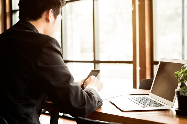 Young businessman work with mobile phones and notebooks in the office, business concept