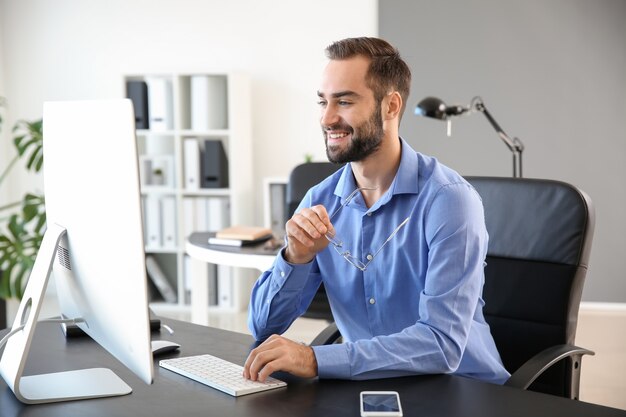 Young businessman working on computer in office