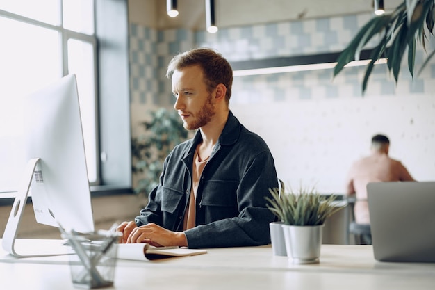 Young businessman working on computer in the office