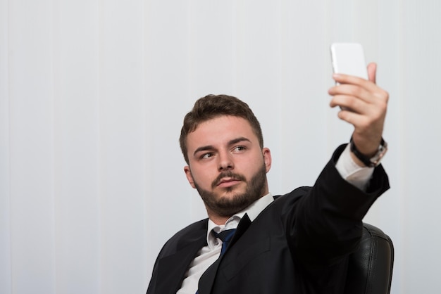 Young Businessman Working In His Office While Talking On The Phone