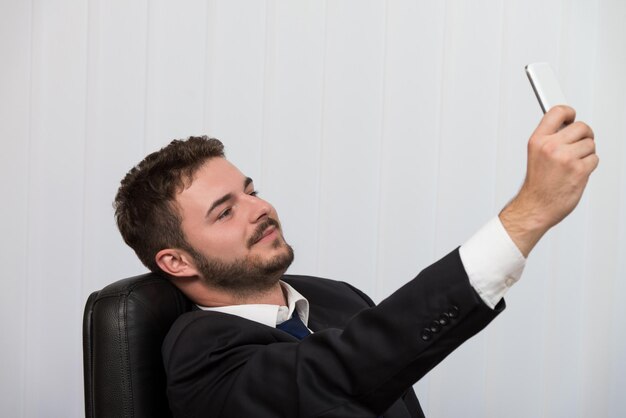 Young Businessman Working In His Office While Talking On The Phone