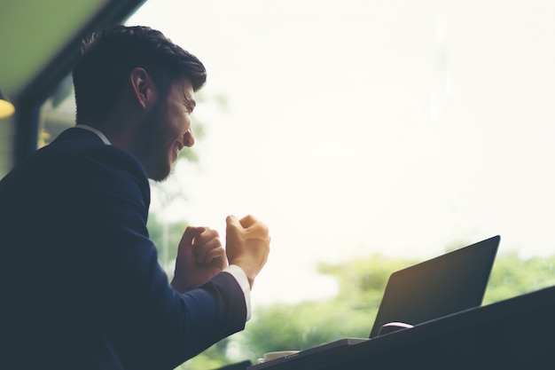 Young businessman working on laptop at office. Working people concept.