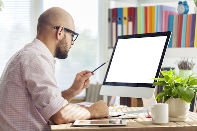 Young businessman working on laptop in the office