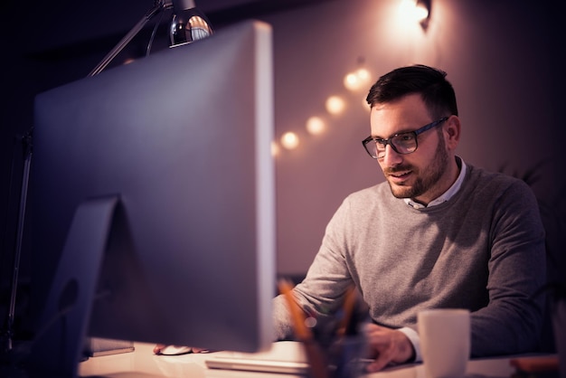 Young businessman working late in home office