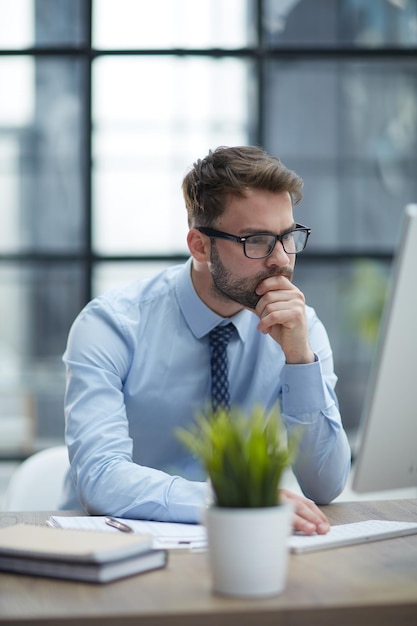 Young businessman working at modern glass office