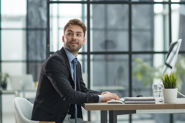 Young businessman working at modern glass office