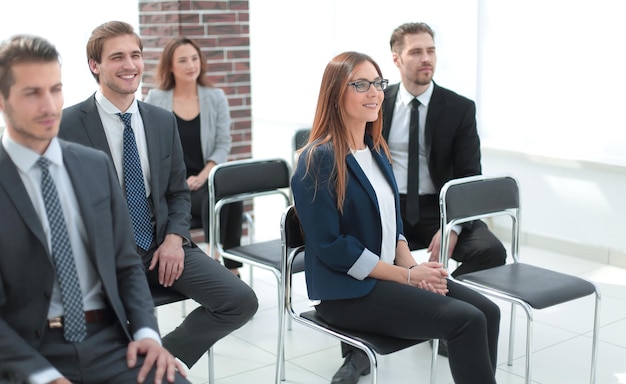 Young businessmen are standing in the office smiling and applauding