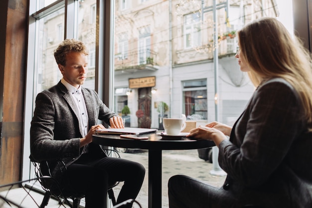 Young businessmen having a meeting in a cafe