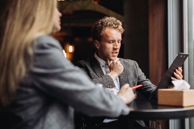 Young businessmen having a meeting in a cafe