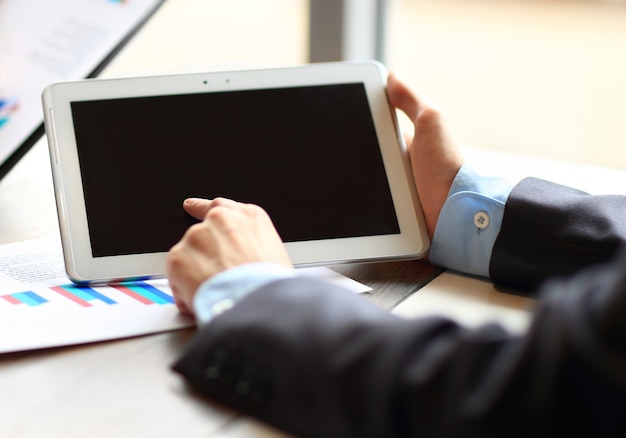  young businessmen using touchpad at meeting