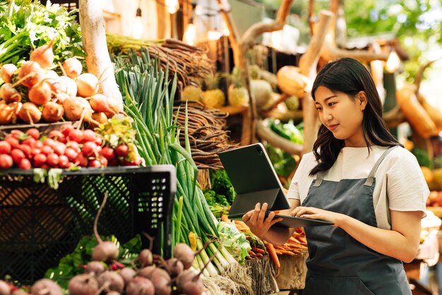 Young businesswoman in an apron working at a local food market