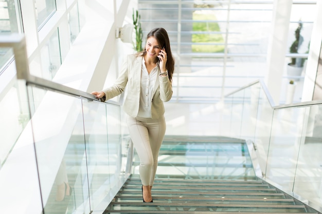 Young businesswoman climbs the stairs