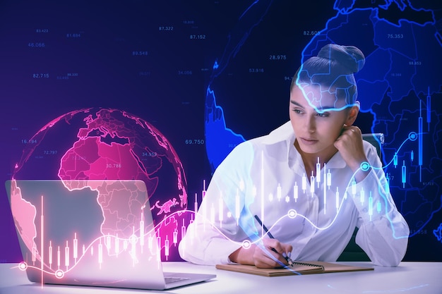 Young businesswoman doing paperwork and desk with laptop and glowing falling red forex chart and globe on blurry background Global economy recession and crisis concept Double exposure